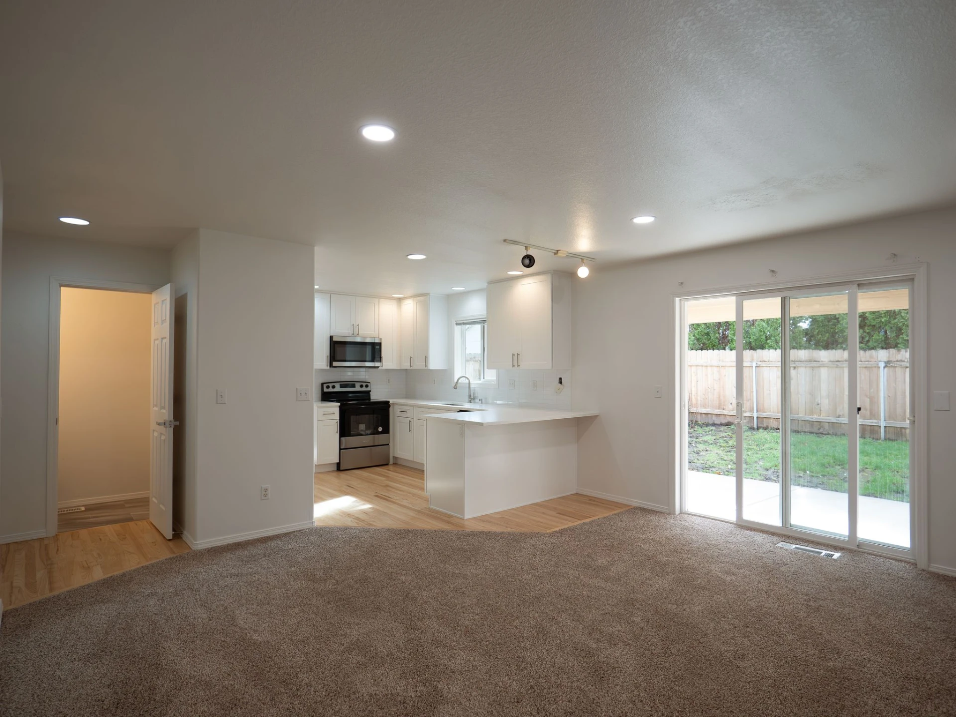 Harris & Sons open living space with a renovated kitchen and patio doors